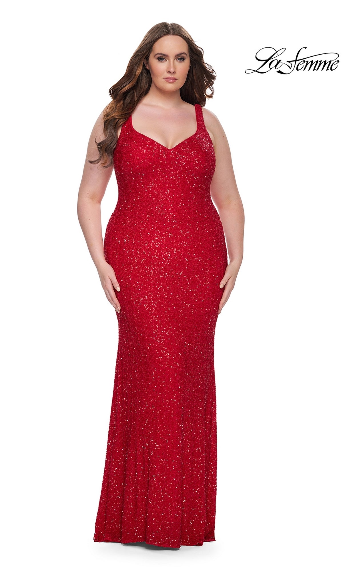 A woman models the La Femme Long Prom Dress 31163 in red, a sleeveless, floor-length plus-size sequin gown, standing against a white background with the La Femme logo visible in the corner.